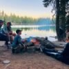 people camping in front of lake